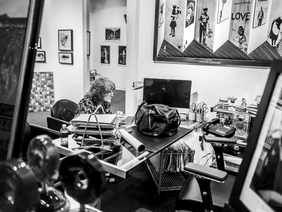 A black-and-white view through windows into a studio office in New York Windows by Lloyd Bishop